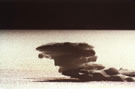An image of a small iceberg of strange form floating on a lake at El Morado National Park.