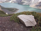 An image of Yeso Lake (Embalse Yeso) with a gypsum stone in the foreground.