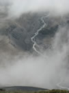 An  image of a river flowing, viewed from above through the clouds, Mondaca Trail, Radal Siete Tazas National Park, Chile.