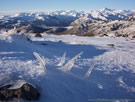 View of snow-covered mountains with icicles covering plants, in the evening, Vilches, Chile.